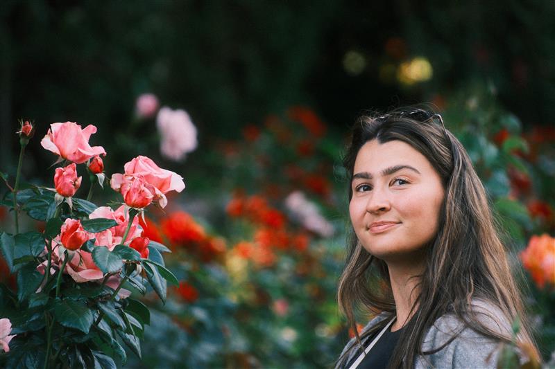 Katie Klabacka standing in a rose garden
